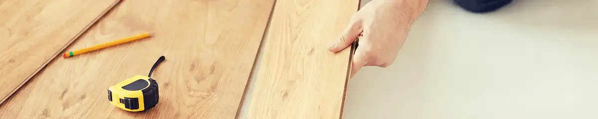 A professional installing wood flooring in Portland, OR