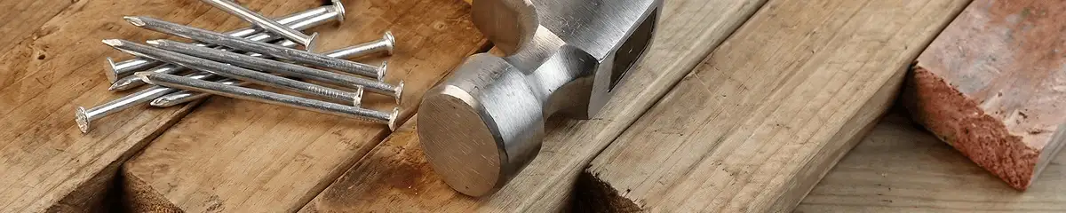 Hammer and nails on hardwood flooring boards in Portland, OR